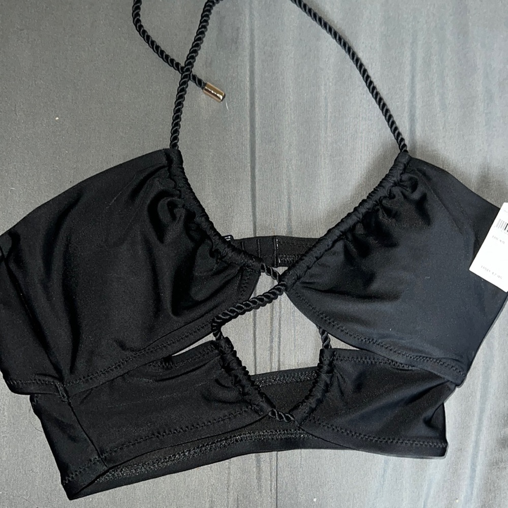 Black halter bikini top with cutouts, clasp in back, padding